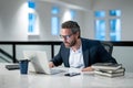 Middle aged businessman working with laptop in office. Hispanic business man using laptop. Millennial man using laptop Royalty Free Stock Photo