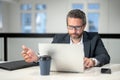 Middle aged businessman working with laptop in office. Hispanic business man using laptop. Millennial man using laptop Royalty Free Stock Photo