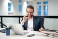 Middle aged businessman working with laptop in office. Hispanic business man using laptop. Millennial man using laptop Royalty Free Stock Photo