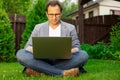 Middle aged businessman working on laptop outdoors, checking stock market Royalty Free Stock Photo