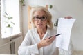 Aged businesswoman giving online presentation discuss contract details distantly