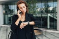 Middle-aged businesswoman looking at her smartwatch Royalty Free Stock Photo