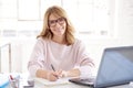 Middle aged businesswoman sitting at office desk and working on business plan Royalty Free Stock Photo