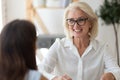 Middle-aged businesswoman talk with business client at office meeting