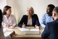 Middle aged businesswoman team leader speaking at corporate meeting Royalty Free Stock Photo