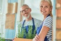 Middle aged caucasian couple in garden house with growing rosemary Royalty Free Stock Photo