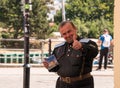 Middle aged caucasian man in German uniform smiling and giving thumbs up and holding a CD case