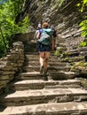 Middle aged Caucasian redheaded woman climbing stairs at Watkins Glen State Park, New York, United States Royalty Free Stock Photo