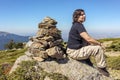 Middle-aged Caucasian woman resting at the top of a mountain Royalty Free Stock Photo