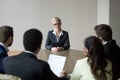 Middle-aged confident applicant talking to hr managers during job interview Royalty Free Stock Photo