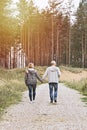 Middle-aged couple of baby boomers people walking in forest