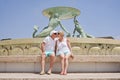 Middle-aged couple of baby boomers people posing for photograph opposite famous fountain