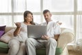 Middle aged couple with a computer