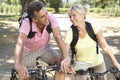 Middle Aged Couple Cycling Through Countryside Royalty Free Stock Photo