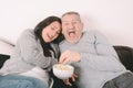 Middle-aged couple eating popcorn and watching a movie Royalty Free Stock Photo