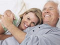 Middle Aged Couple Embracing In Bed Royalty Free Stock Photo