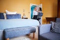 Middle aged couple embracing in the doorway of a hotel room Royalty Free Stock Photo