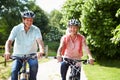 Middle Aged Couple Enjoying Country Cycle Ride Together Royalty Free Stock Photo