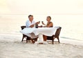 Middle aged couple enjoying romantic dinner at the beach. Shot of a mature couple enjoying a romantic dinner on the Royalty Free Stock Photo