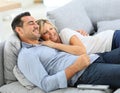 Middle-aged couple enjoying watching tv