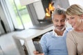 Middle-aged couple by fireplace at home Royalty Free Stock Photo