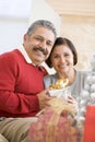 Middle Aged Couple Holding Christmas Present