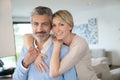 Middle-aged couple at home embracing