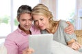 Middle-aged couple at home using tablet Royalty Free Stock Photo
