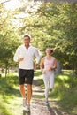 Middle Aged Couple Jogging In Park Royalty Free Stock Photo