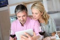 Middle-aged couple in the kitchen drinking wine Royalty Free Stock Photo