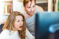 Middle-aged couple looking surprised at computer at home Royalty Free Stock Photo