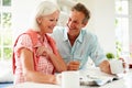 Middle Aged Couple Reading Magazine Over Breakfast Royalty Free Stock Photo