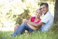 Middle Aged Couple Relaxing In Countryside Leaning Against Tree Royalty Free Stock Photo