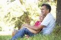 Middle Aged Couple Relaxing In Countryside Leaning Against Tree Royalty Free Stock Photo