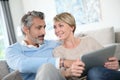 Middle-aged couple spending time on tablet Royalty Free Stock Photo