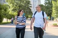 Middle-aged couple in sportswear walking and talking in the park Royalty Free Stock Photo