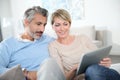 Middle-aged couple surfing on tablet Royalty Free Stock Photo