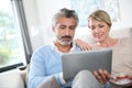 Middle-aged couple on tablet websurfing Royalty Free Stock Photo