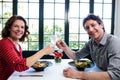 Middle-aged couple toasting champagne flutes while having lunch Royalty Free Stock Photo