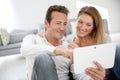 Middle-aged couple using tablet at home Royalty Free Stock Photo