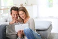 Middle-aged couple using tablet at home Royalty Free Stock Photo