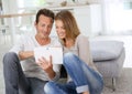 Middle-aged couple using tablet at home Royalty Free Stock Photo