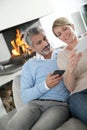 Middle-aged couple using their smartphones at home Royalty Free Stock Photo