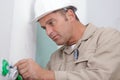 Middle-aged electrician working in renovation property Royalty Free Stock Photo