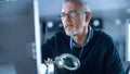 Middle Aged Electronics Repair Engineer Working on Personal Computer in His Workshop, Optical Lens Royalty Free Stock Photo