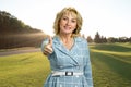 Middle aged elegant woman raised thumb up. Royalty Free Stock Photo