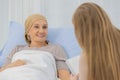 A middle-aged end-state breast cancer patient lay on the bed and tells her life`s story for a ghostwriter to write her biography