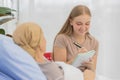 A middle-aged end-state breast cancer patient lay on the bed and tells her life`s story for a ghostwriter to write her biography