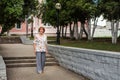 An elderly energetic lady strolling along the city path in a cheerful mood Royalty Free Stock Photo