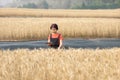 Middle aged farmer is checking quality and analyzing plants of barley in field